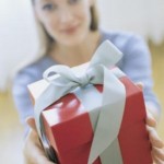 Woman Giving Gift, Portrait, Blurred. --- Image by © Royalty-Free/Corbis